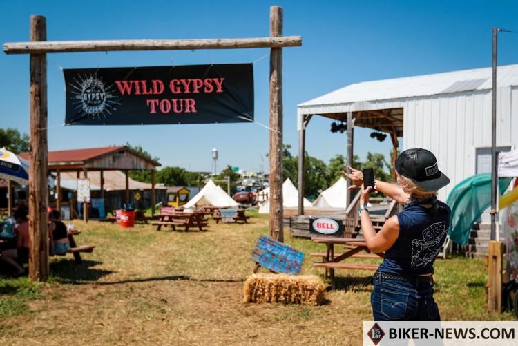 Samantha Ray, from California, takes a picture at the entrance to the Wild Gypsy Tour compound in The Sturgis Buffalo Chip Campground on day two of the Sturgis motorcycle rally on Saturday in Sturgis.  Adam Fondren, Journal Staff