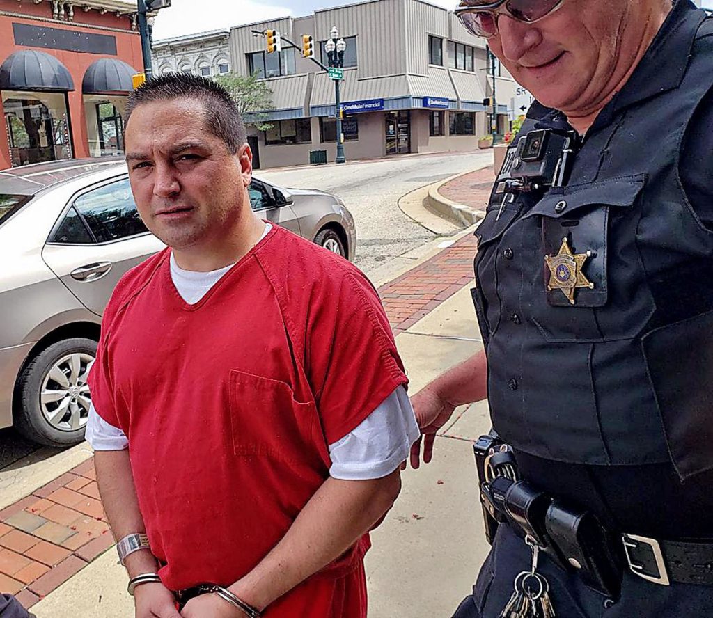 Suspected Pagan Motorcycle Club member Joseph T. Olinsky III leaves court Wednesday following his hearing in an attempted homicide case in Charleroi.