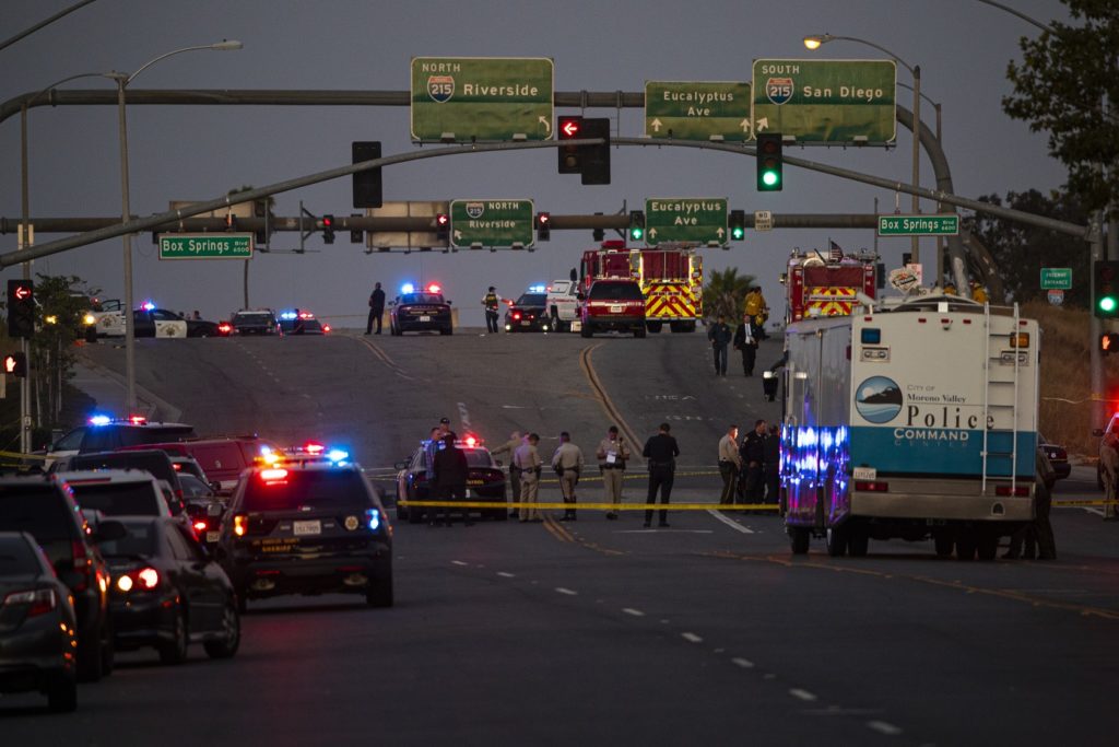 Police investigate the scene where a California Highway Patrol officer was killed in Riverside County. (Gina Ferazzi / Los Angeles Times)