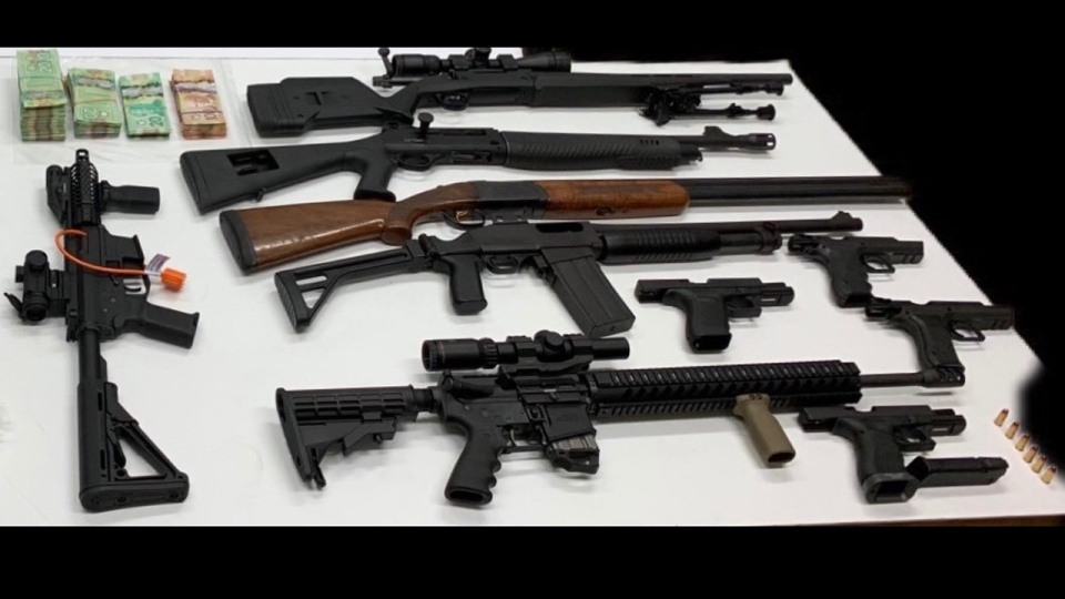 Firearms including two assault-style rifles and a combat shotgun seized during Project Skylark are shown in an OPP handout image.