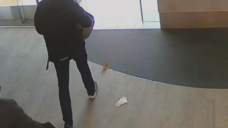 a man riding a skateboard up the side of a ramp: The man and woman entered the Burleigh Waters Suncorp Bank yesterday and stole $5000 in cash, but dropped some on their way out.